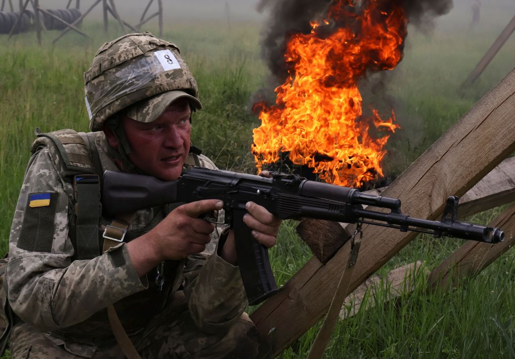 A handout photo made available by the press service of the 65th Separate Mechanised Brigade shows new recruits of the 65th Separate Mechanised Brigade attending their training on an obstacle course with psychological elements and a tank used on a shooting range in the Zaporizhzhia, Ukraine, 26 May 2025