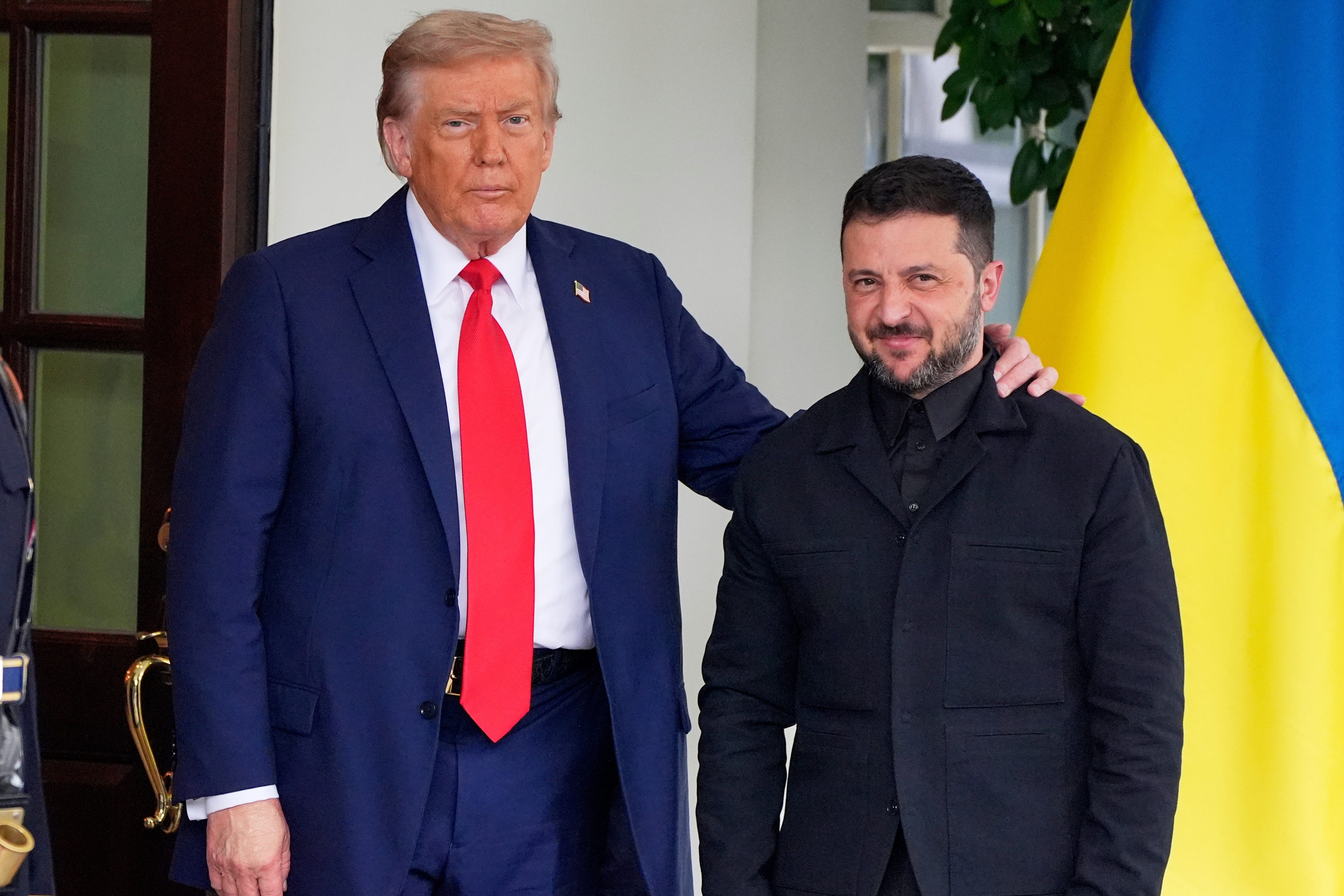 President Donald Trump, left, greets Ukraine's President Volodymyr Zelenskyy as he arrives at the White House, Monday, Aug. 18, 2025, in Washington.