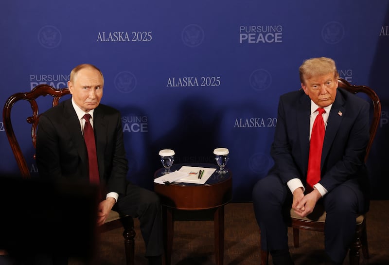 Russian President Vladimir Putin (L)looks on as U.S. President Donald Trump (R) reacts during their meeting on war in Ukraine at Joint Base Elmendorf-Richardson on August 15, 2025 in Anchorage, Alaska.