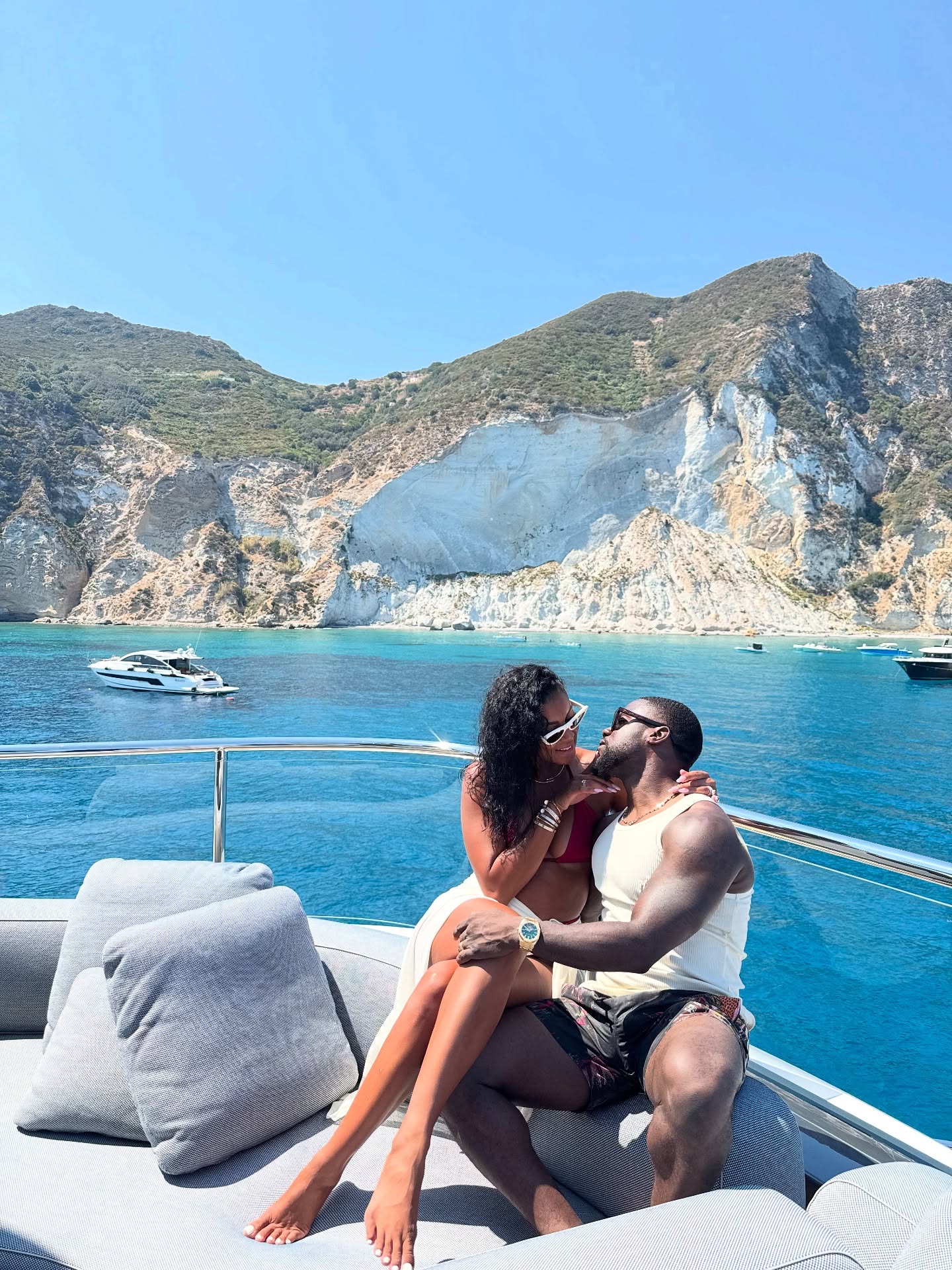 Kevin Hart and wife Eniko Hart celebrate her birthday in a cuddle up snap while on a boat on vacation.