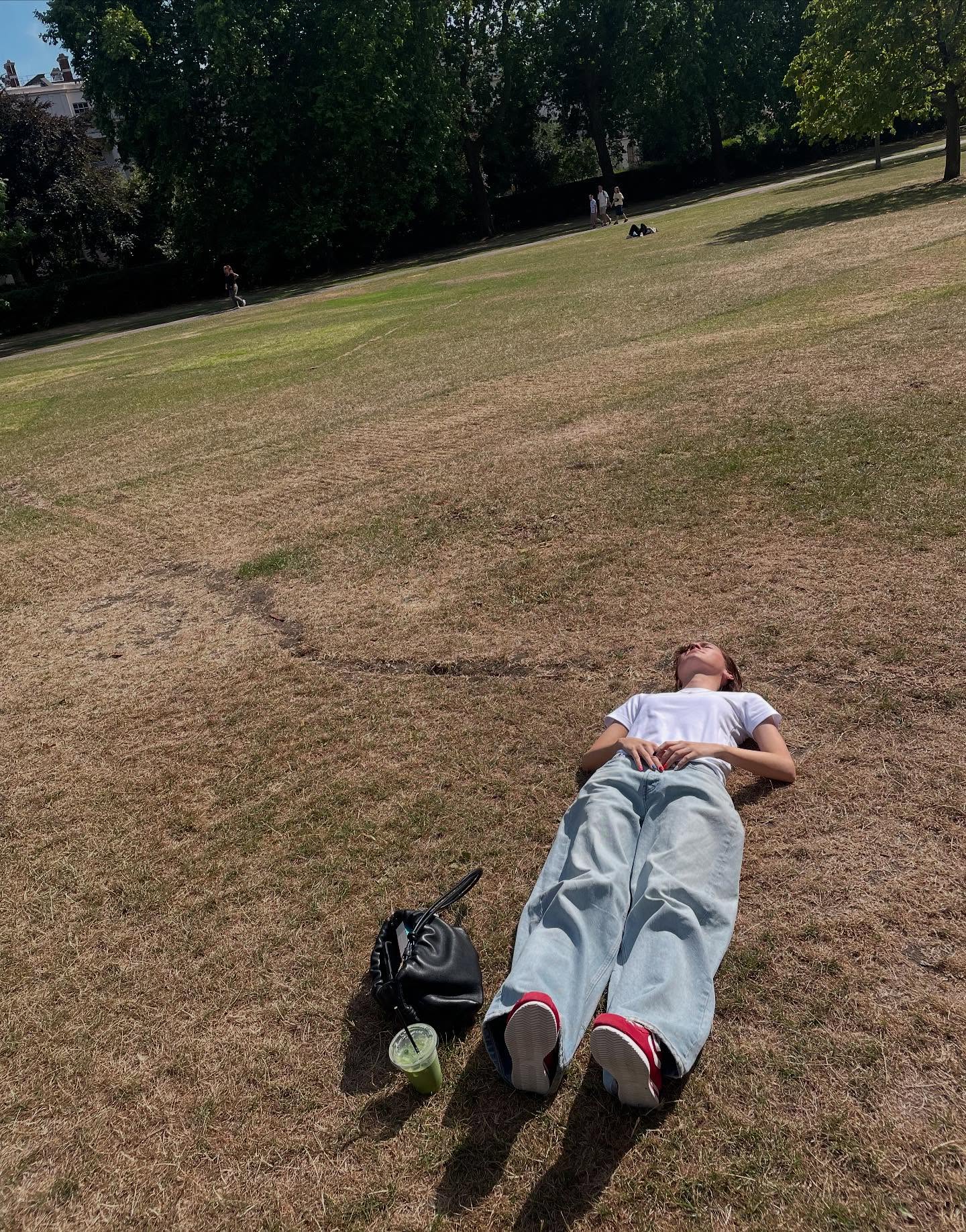 Maude Apatow takes a moment to relax on a lawn.