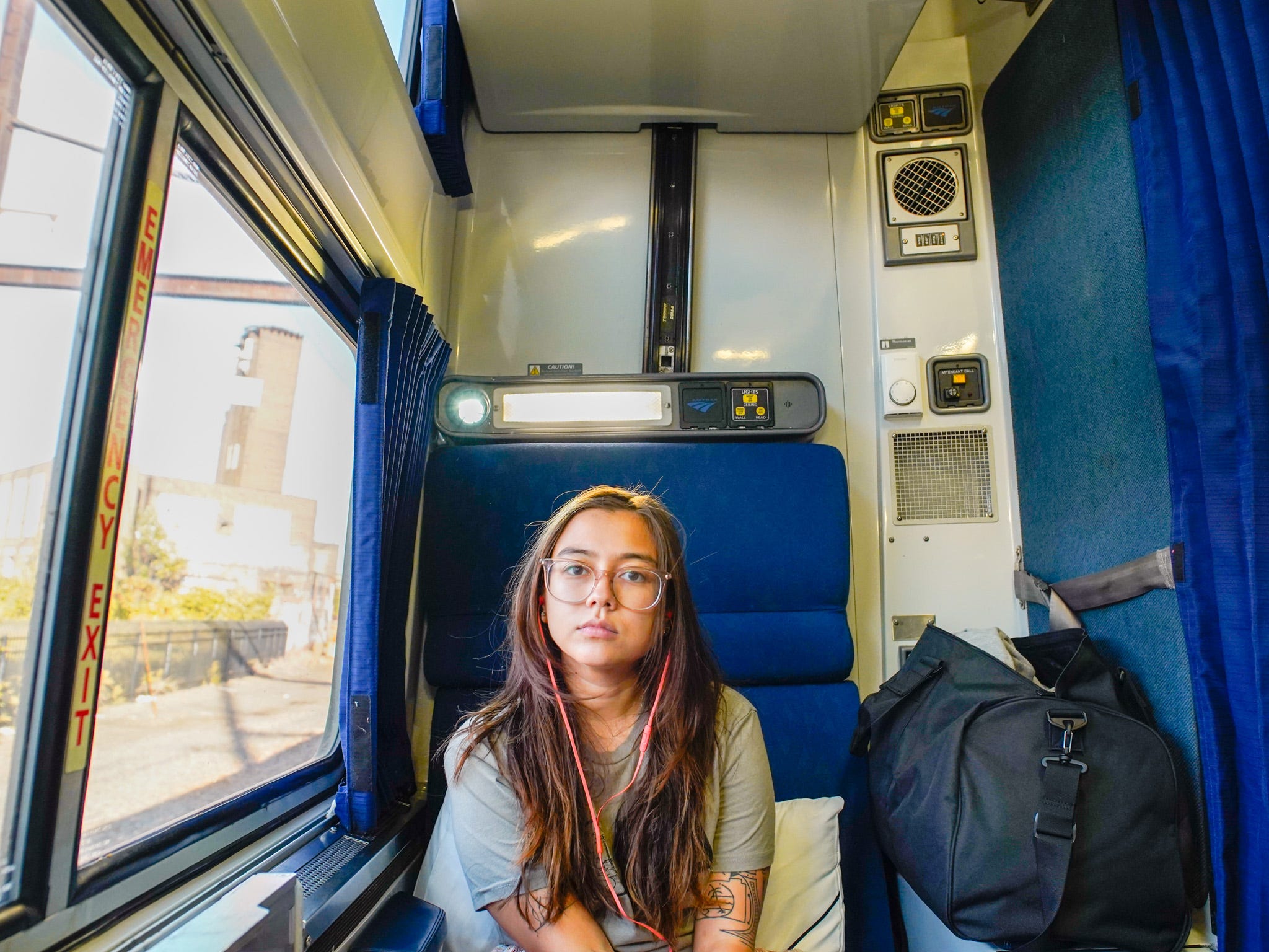 The author sits in a roomette.