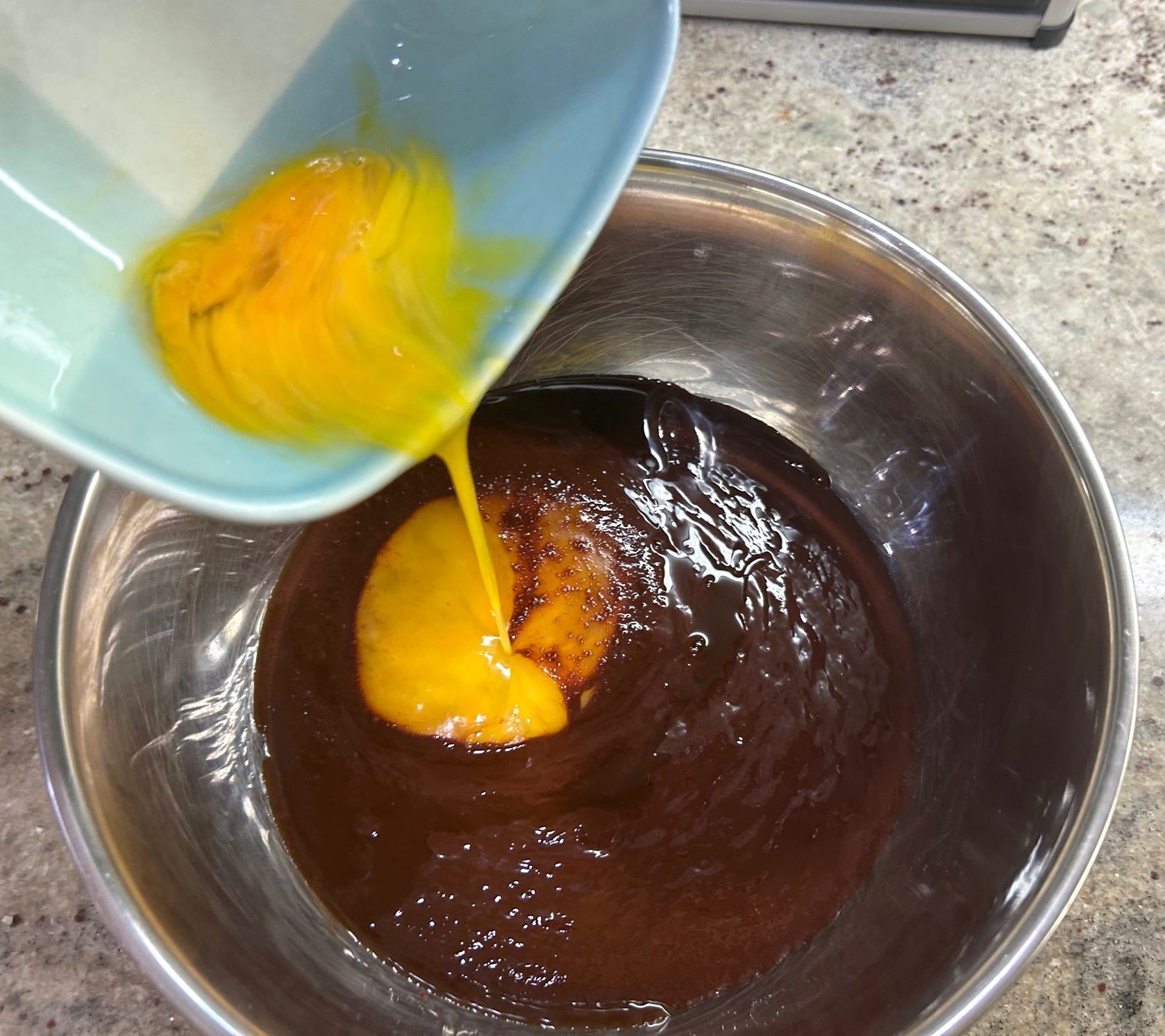 Adding egg to batter for Gordon Ramsay's Brownies
