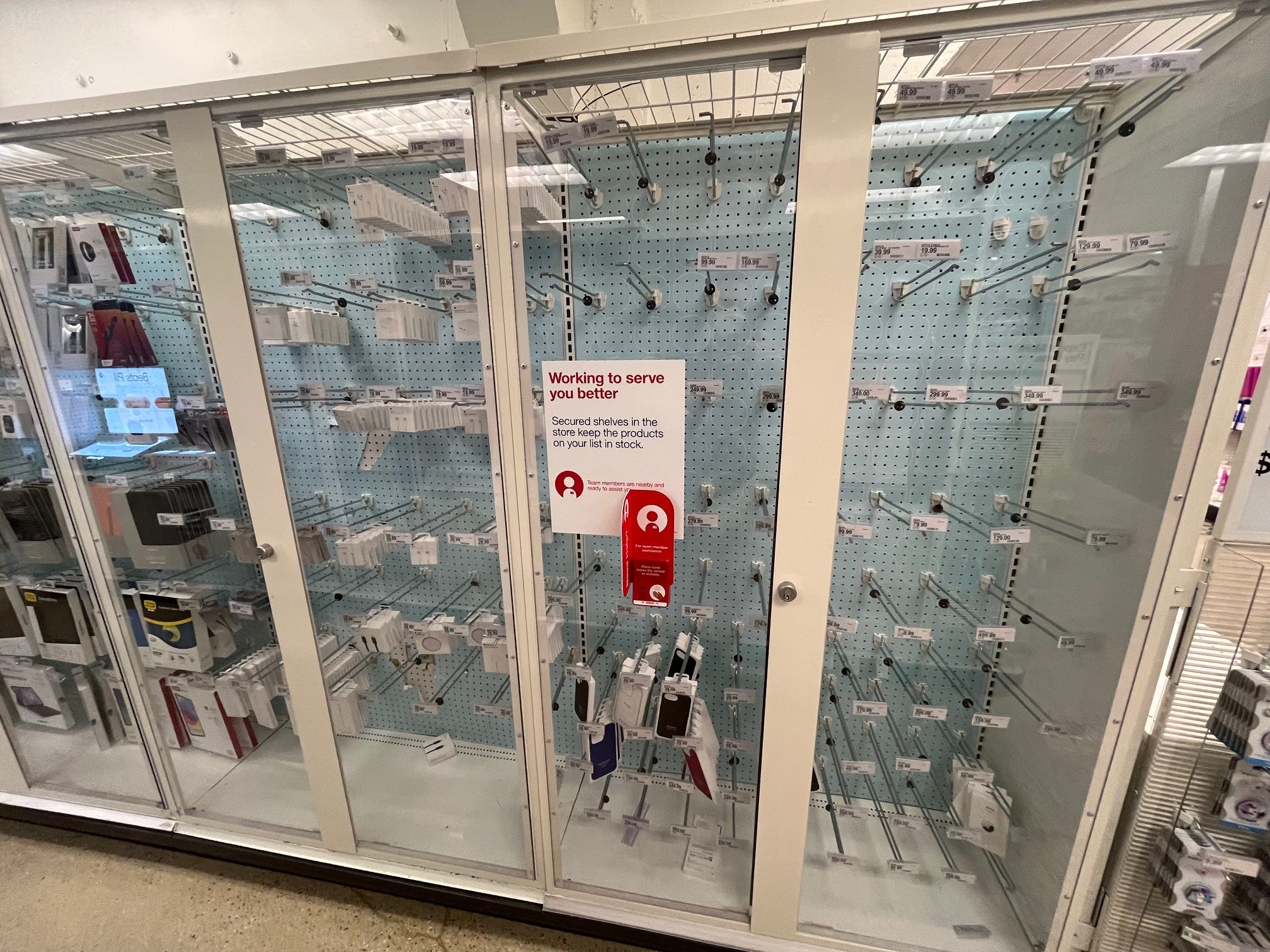 A mostly empty locked case meant to carry Apple accessories such as earbuds and charging cables at a Target store.