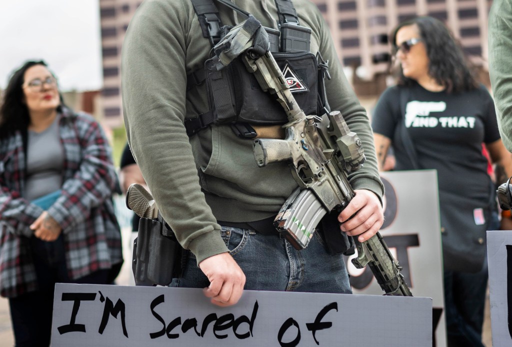 A person carries a rifle in public during a Second Amendment protest in Albuquerque, New Mexico, on Sept. 12, 2023.