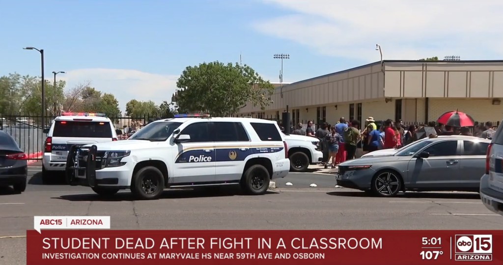 Police cars outside a school; student death after classroom fight.