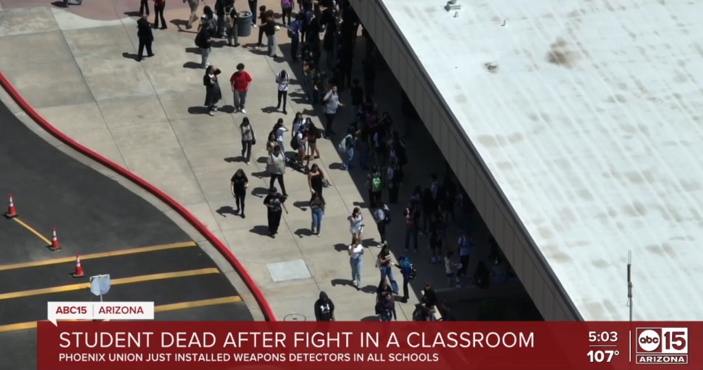 Aerial view of students outside a school building following a fatal classroom fight.