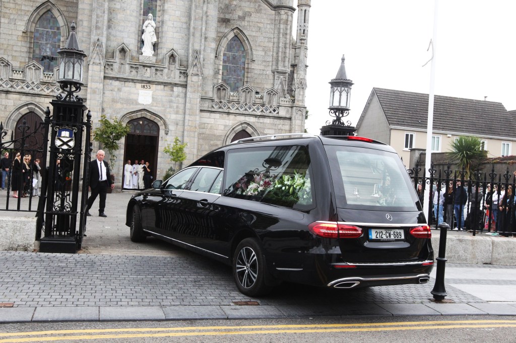 Hearse arriving at a church for Martha Nolan's funeral.