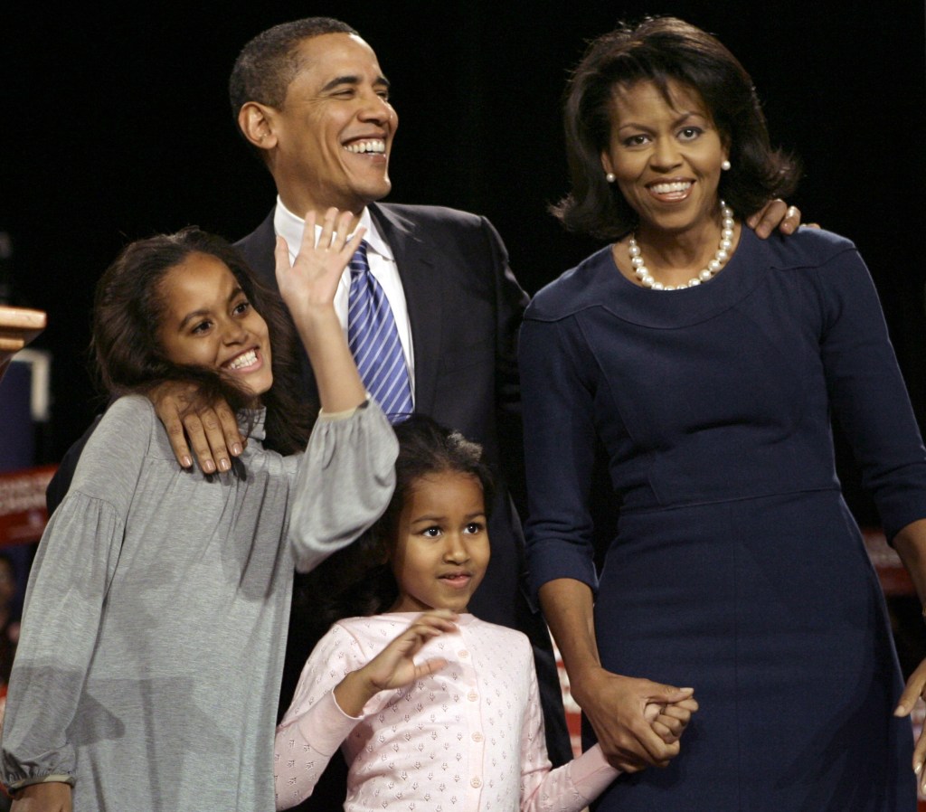 Michelle Obama and Barack Obama with their daughters Sasha and Malia in 2008. 