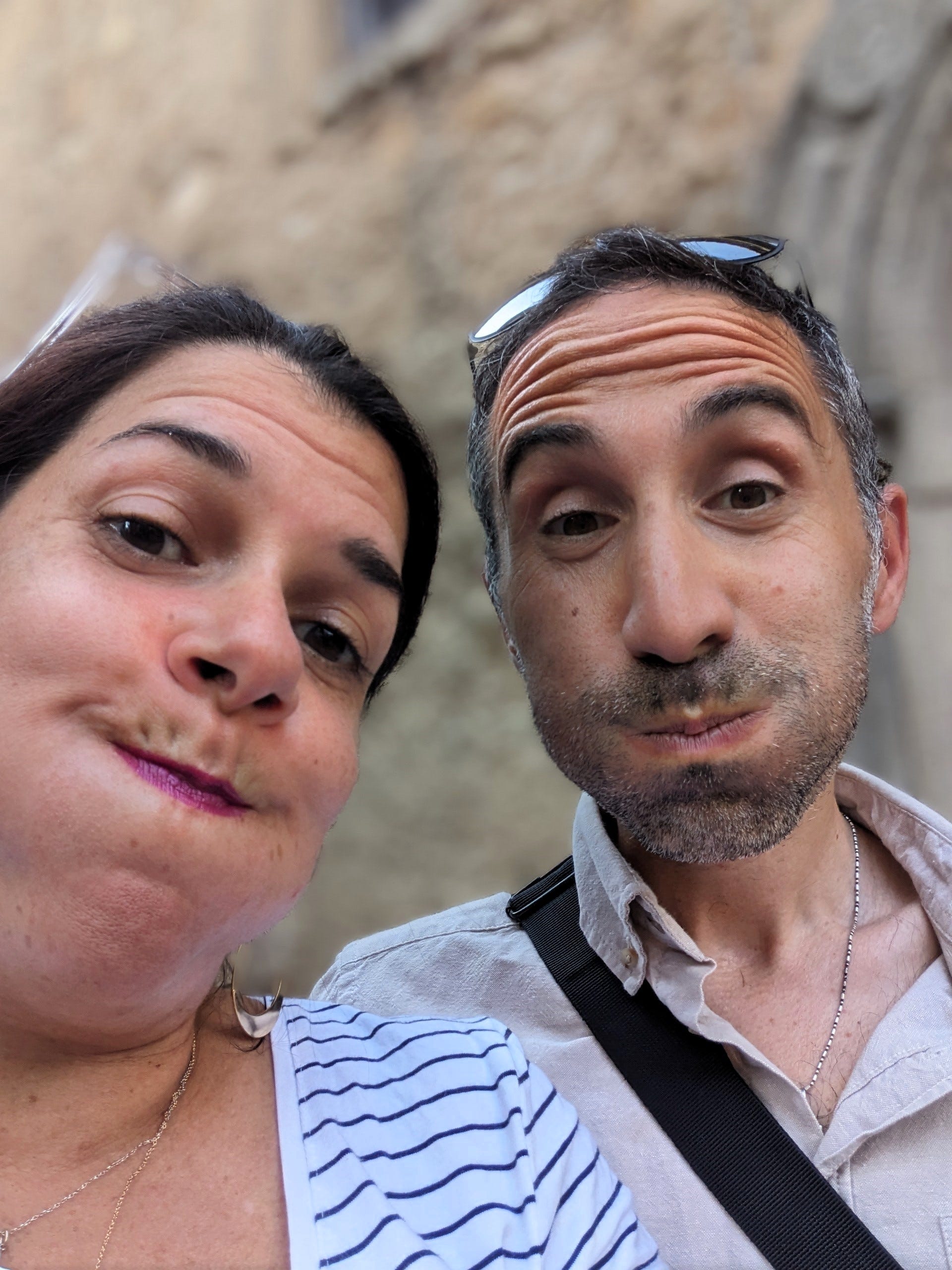 Husband and wife making silly faces at the camera.