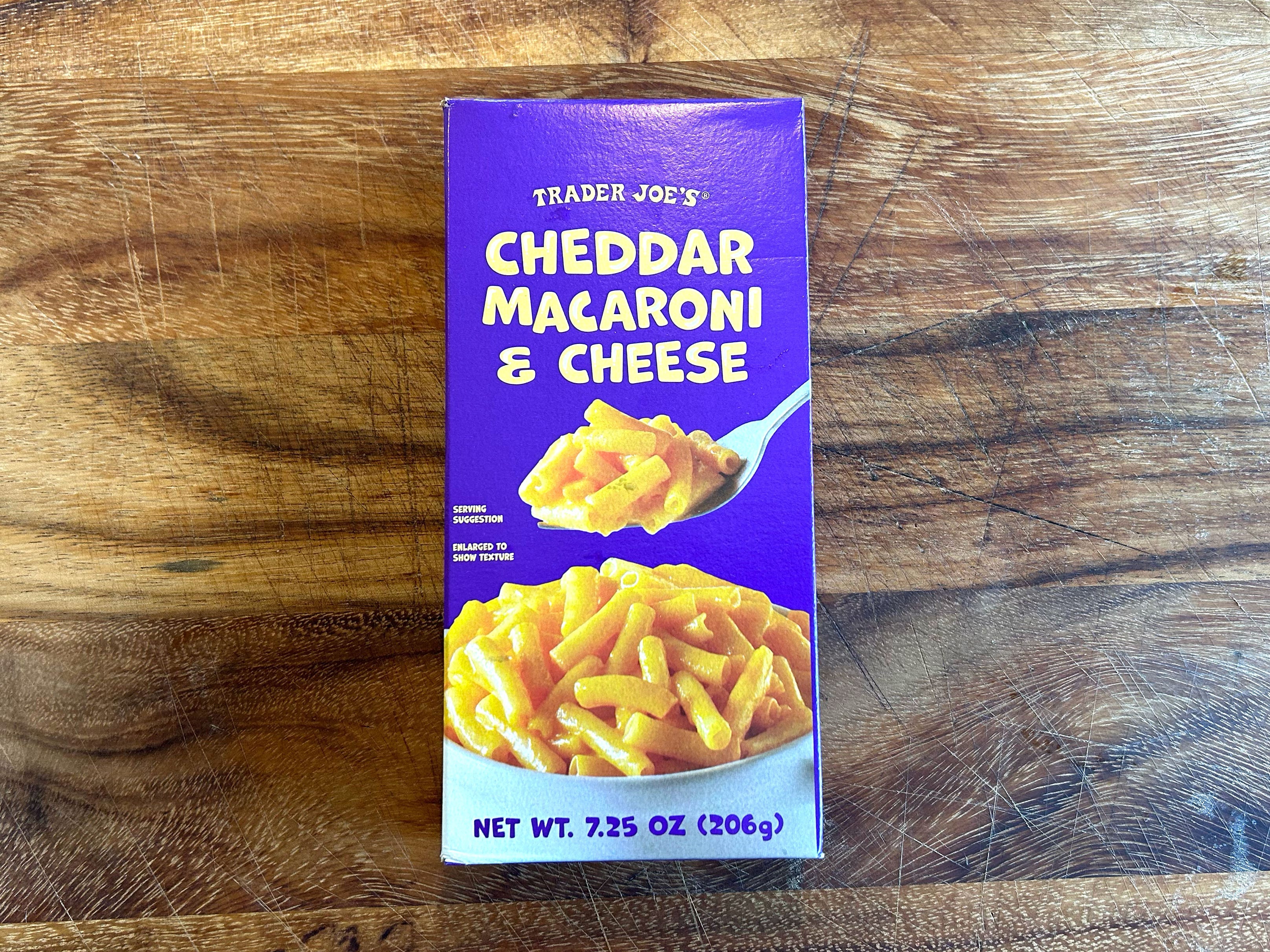 A box of Trader Joe's mac and cheese on a wooden table.