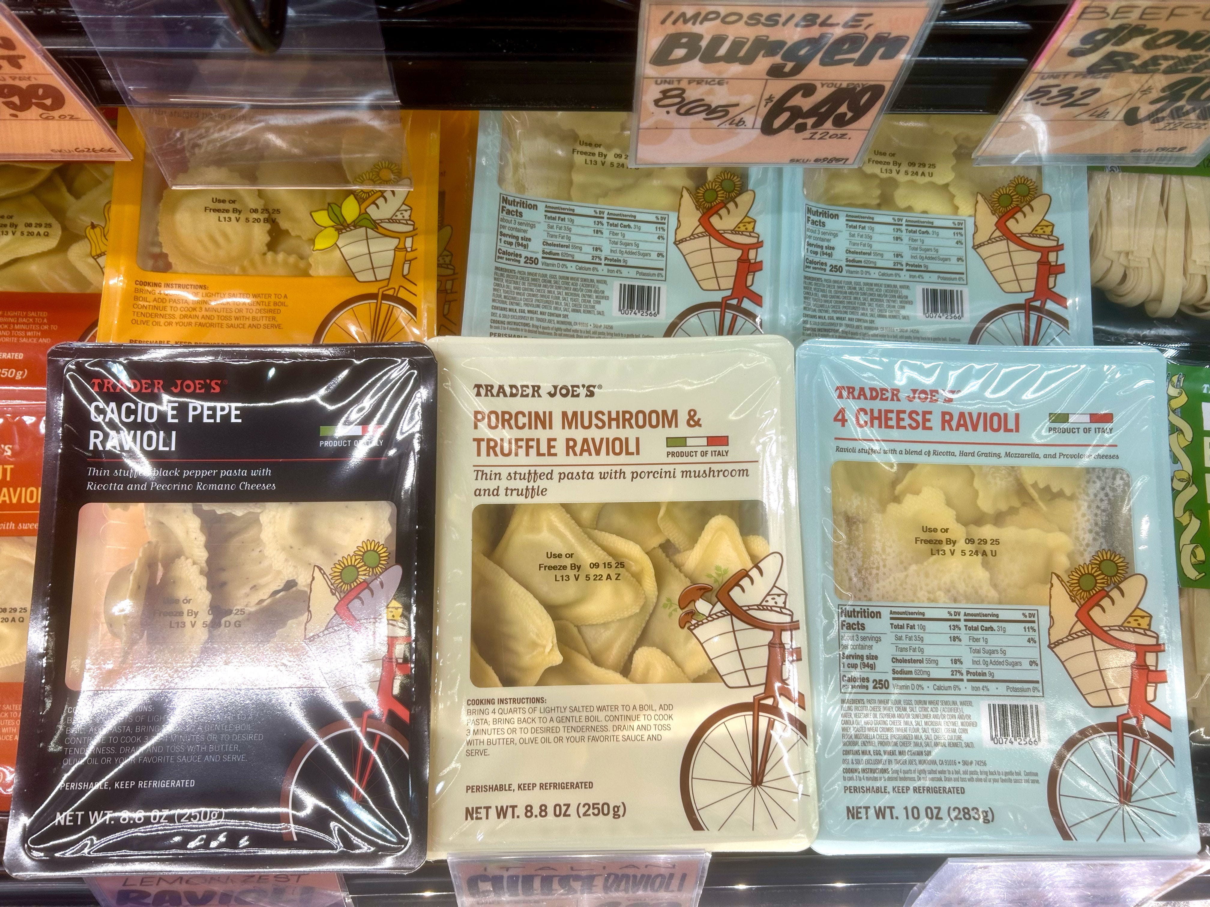 Containers of different varieties of Trader Joe's ravioli in a case.