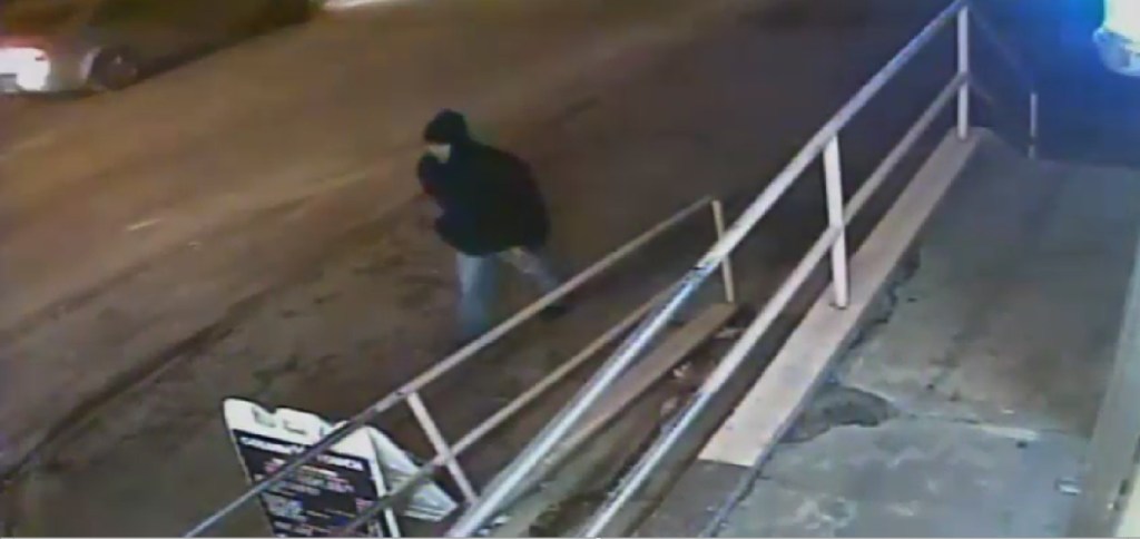 Surveillance footage of a person of interest in a homicide investigation.