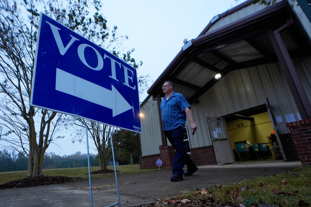 A man walks toward a polling place.