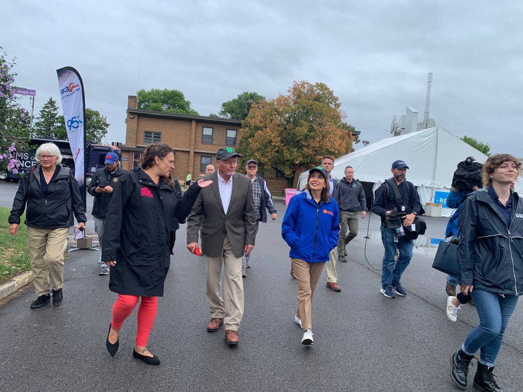 Commissioner Richard Ball and State Fair Director Julie LaFave walking with others.