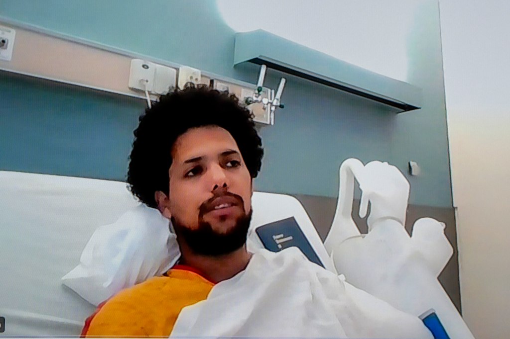 Defendant Christian Aybar in a hospital bed.