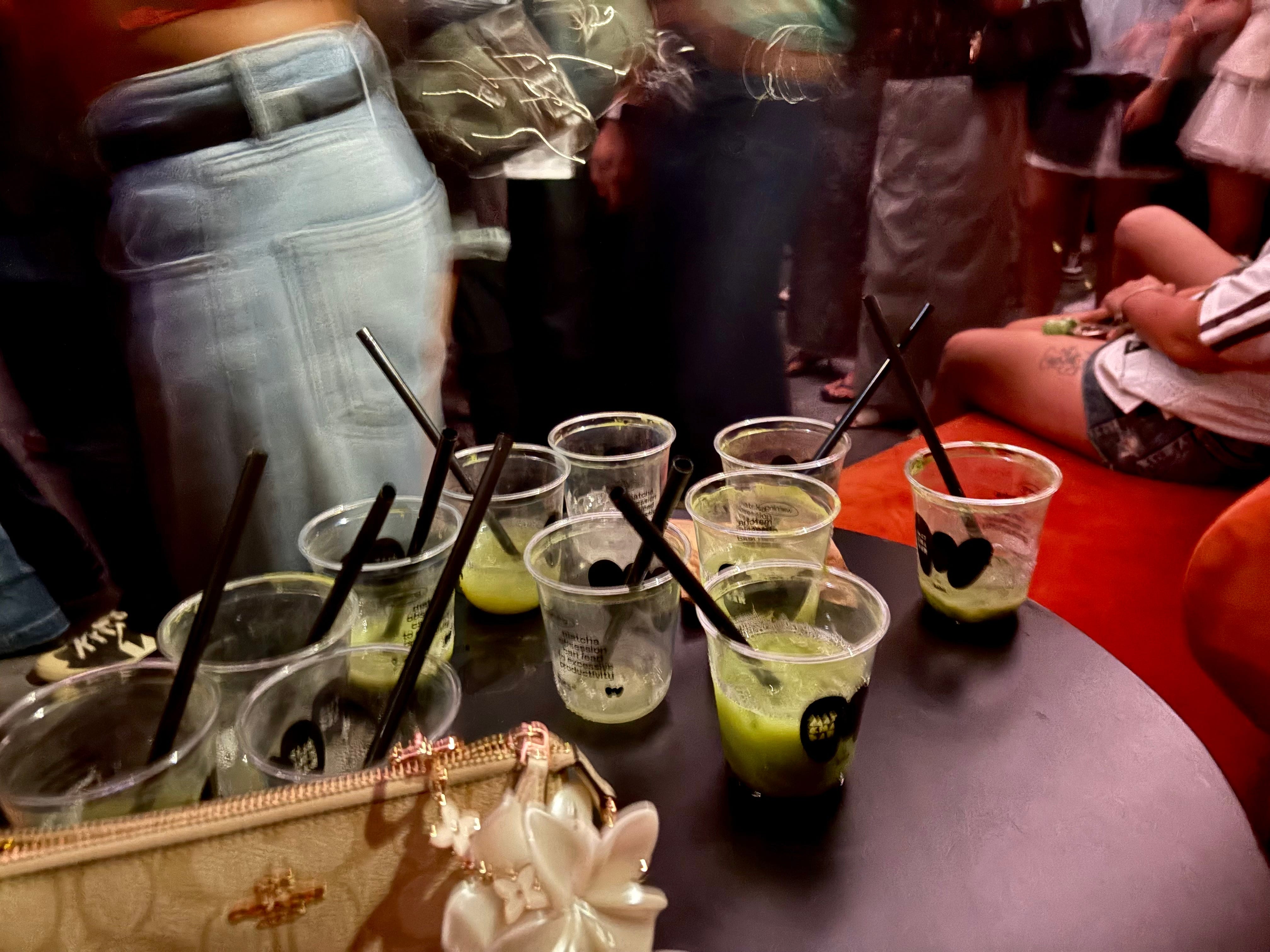 Instead of empty alcoholic drink glasses, empty matcha cups were scattered around tables in the club.