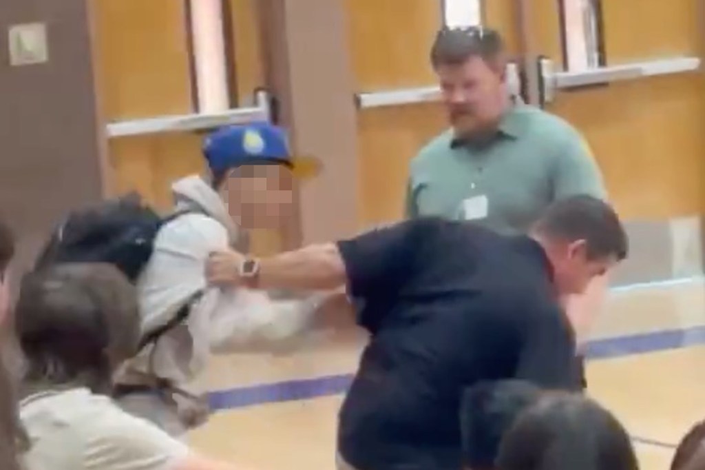 Police officer body slamming a high school student.