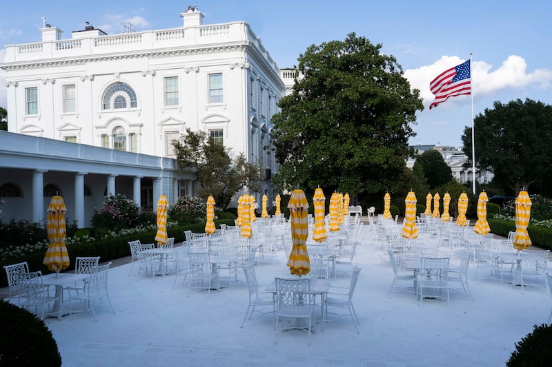 WASHINGTON, DC - AUGUST 16: Metal tables and chairs along with yellow umbrellas decorate a paved over historic White House Rose Garden lawn on August 16, 2025 in Washington, DC. US President Donald Trump is planning to  build a $200 million  ballroom for hosting official receptions, one of the biggest projects at the White House in more than a century. (Photo by Roberto Schmidt/Getty Images)