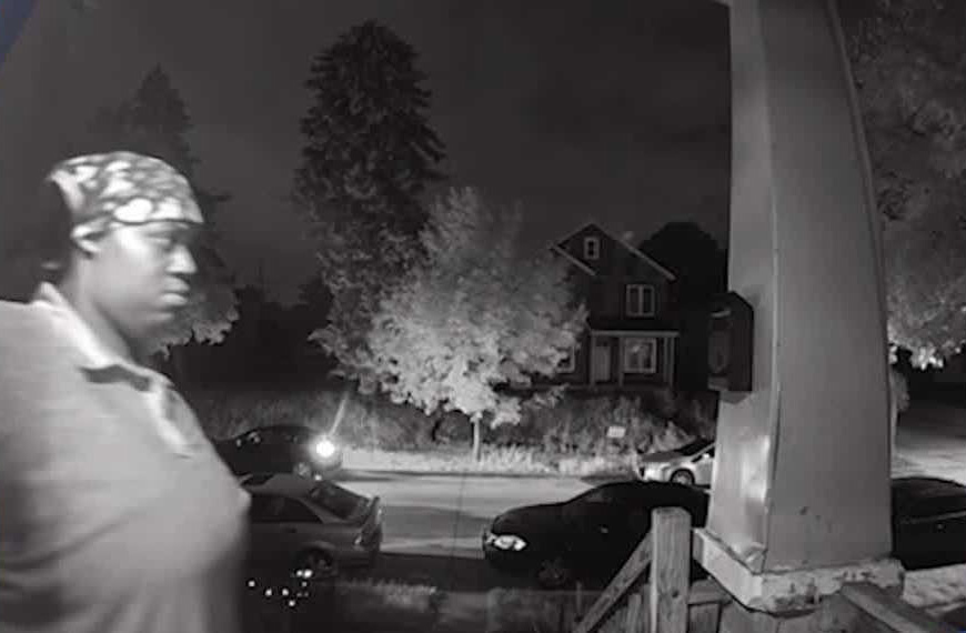 Security camera image of a person suspected of causing $10,000 in damage to a delivery driver's car.