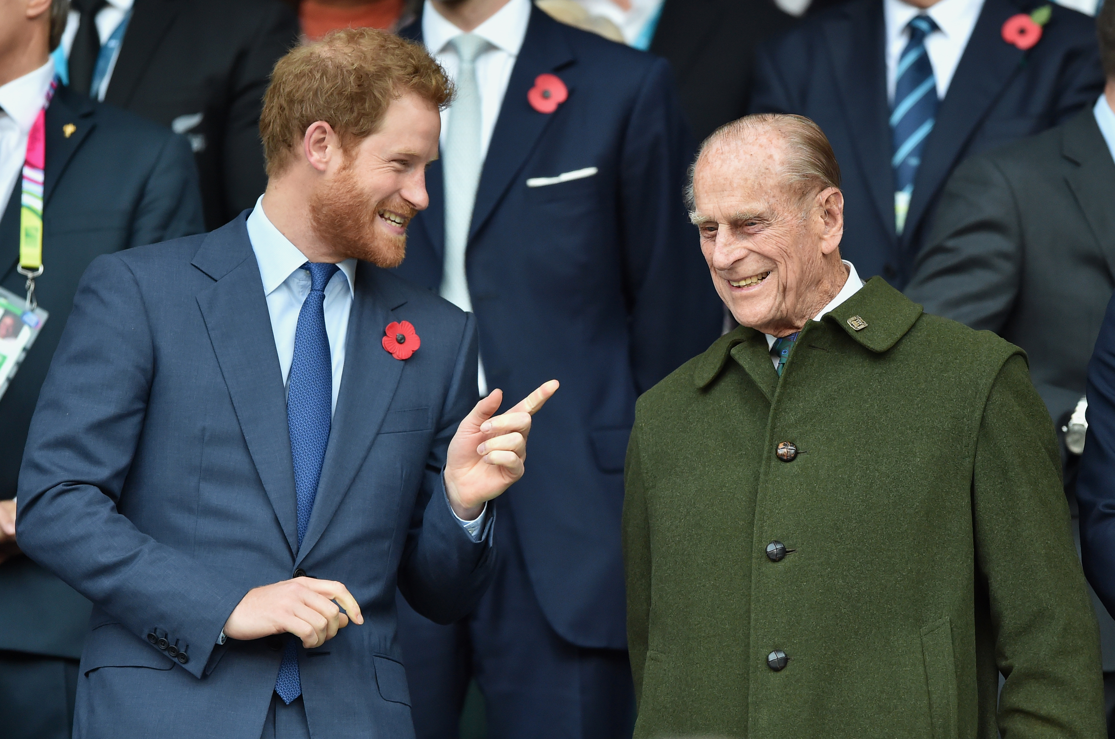 Prince Harry and Prince Philip smile. 