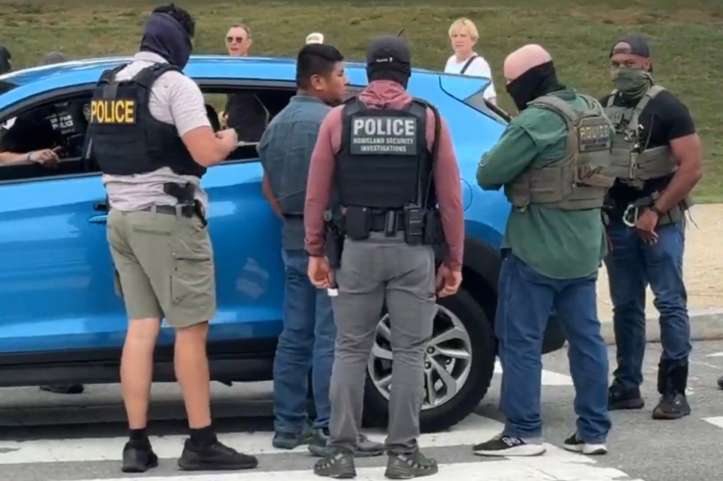 Police officers detaining a man.