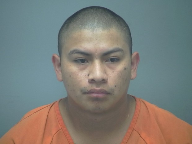 Mugshot of a man in an orange jumpsuit.
