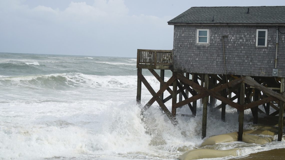 Hurricane Erin stirs up strong winds and floods part of a NC highway as it slowly moves out to sea