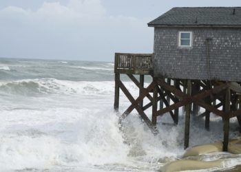 Hurricane Erin stirs up strong winds and floods part of a NC highway as it slowly moves out to sea