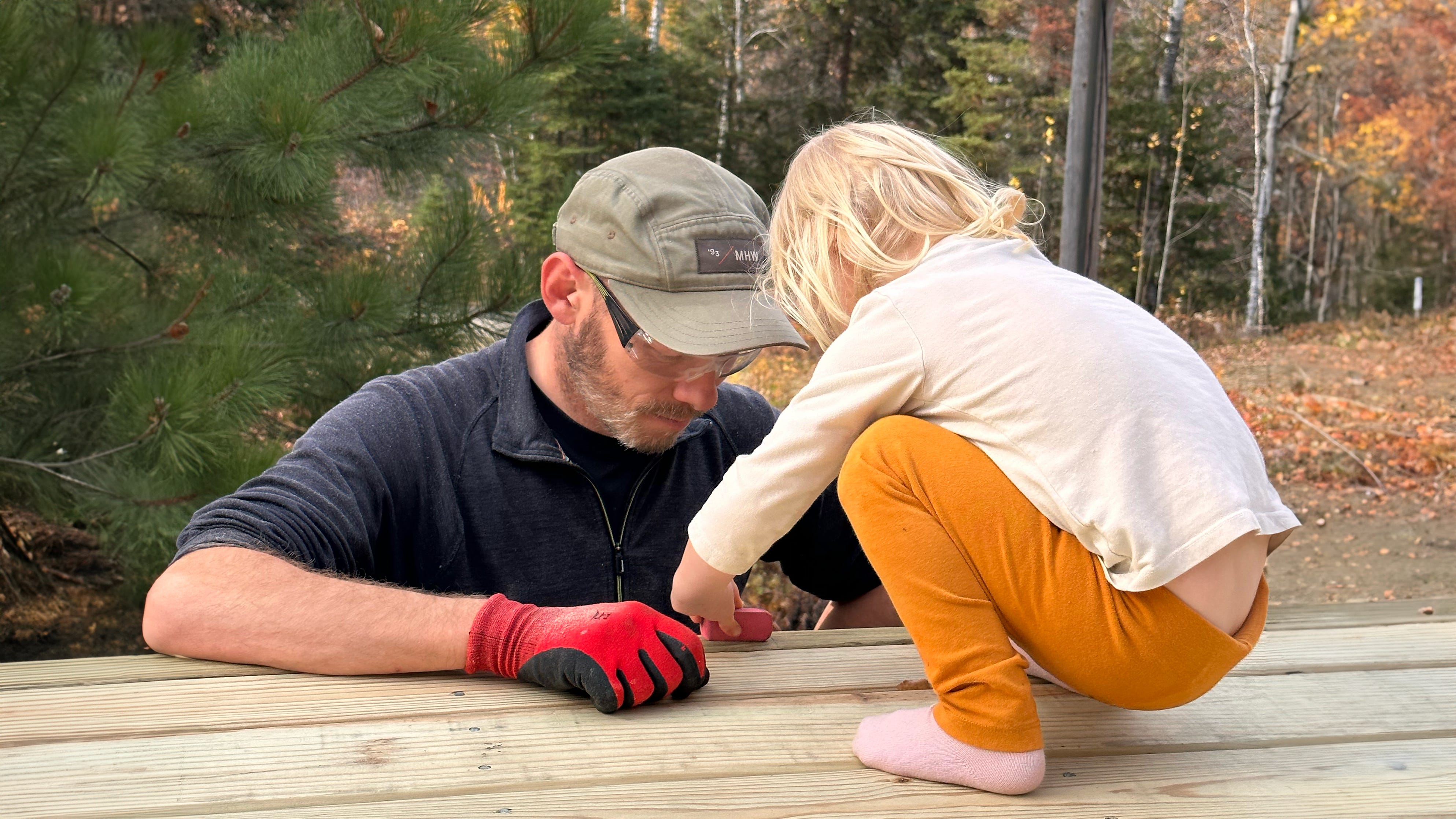 small child helping father with house work