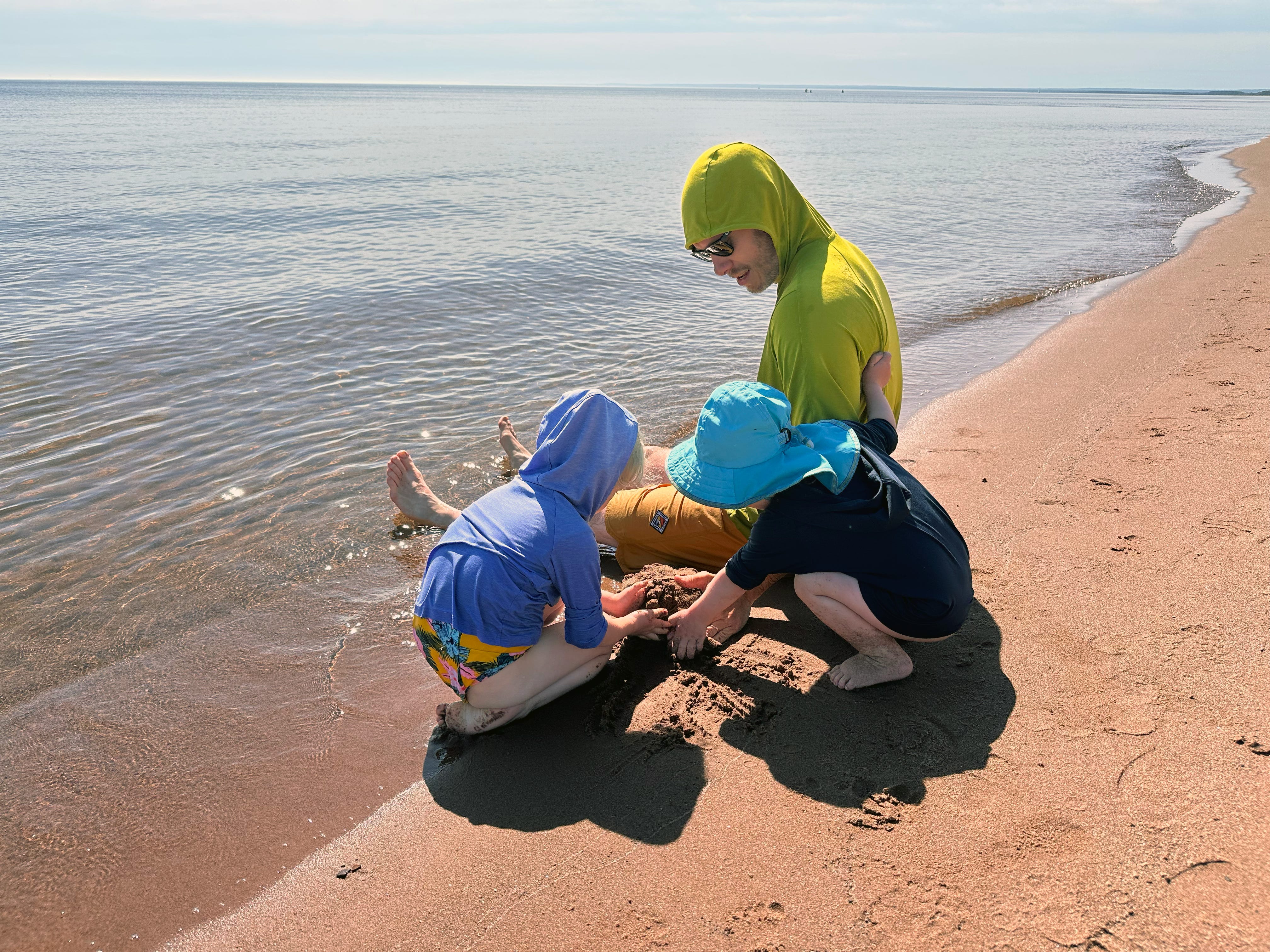 Father and kids at beach.
