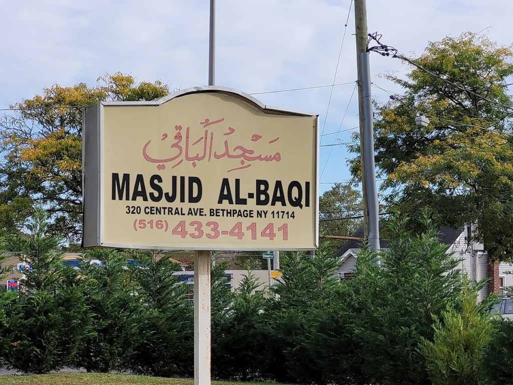 Masjid Al-Baqi sign with address and phone number.