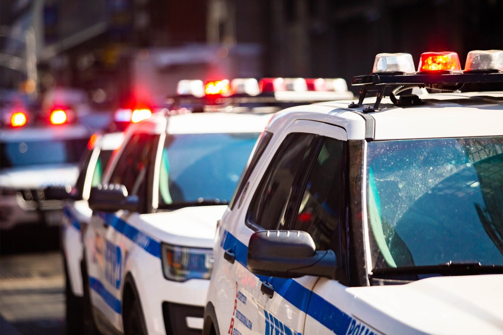 NYPD police cars with lights flashing.