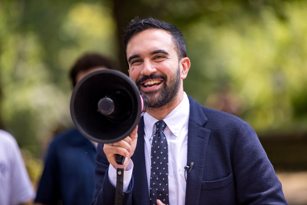 Zohran Mamdani, New York State Assemblymember, speaking into a megaphone.