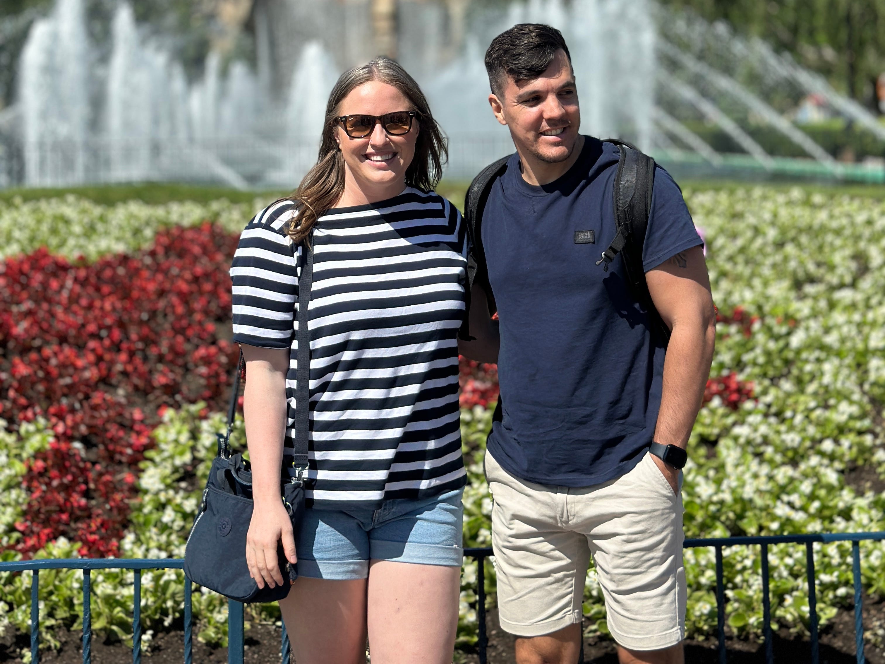 Author Yvonne Ivanescu and husband smiling in front of fountain