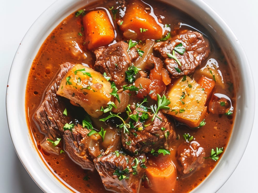a bowl of beef stew in a white bowl