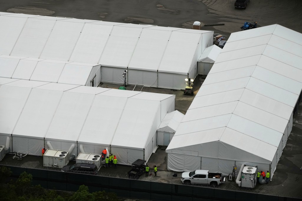 Aerial view of a migrant detention facility under construction.