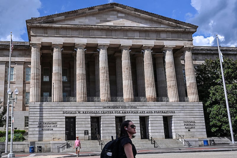 Visitors walk outside the Smithsonian American Art Museum and the National Portrait Gallery is seen in Washington, DC on August 14, 2025. US President Donald Trump on Tuesday criticized top museums for their "woke" focus on subjects including "how bad Slavery was," his latest attack on the cultural institutions in a country that fought a civil war over the issue. (Photo by Alex WROBLEWSKI / AFP) (Photo by ALEX WROBLEWSKI/AFP via Getty Images)