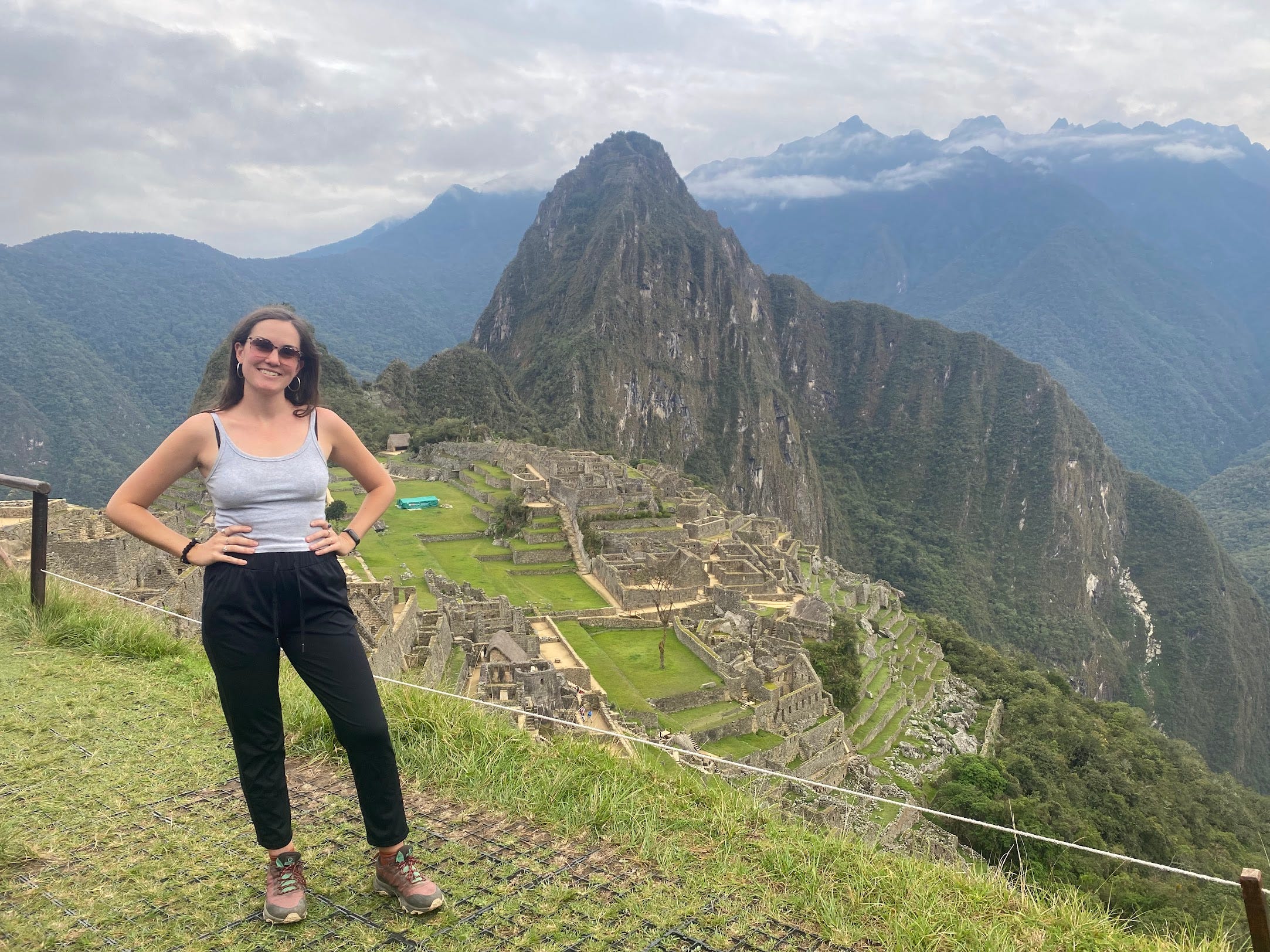 woman standing in front of Machu Picchu