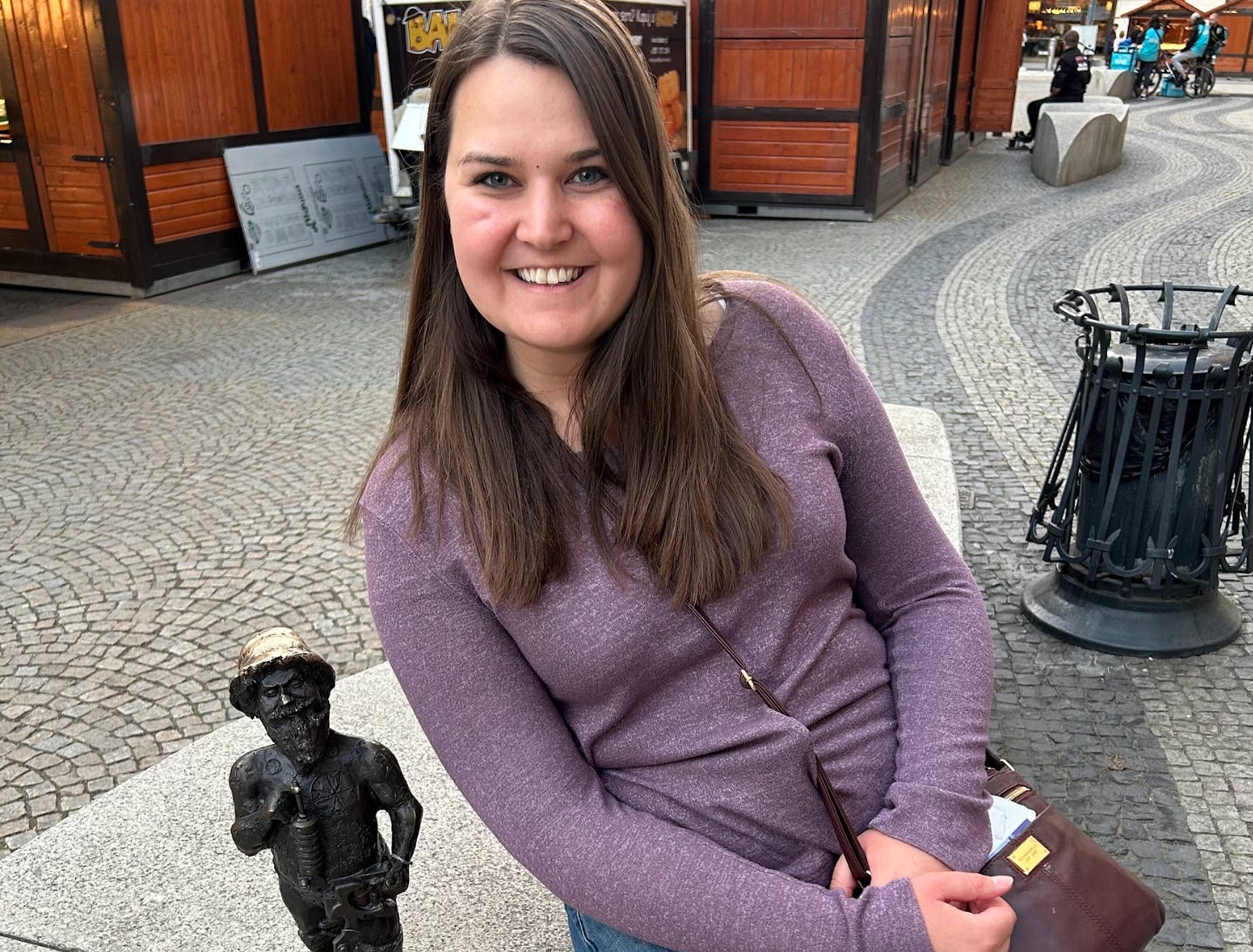 The writer and a small dwarf statue in Wroclaw.