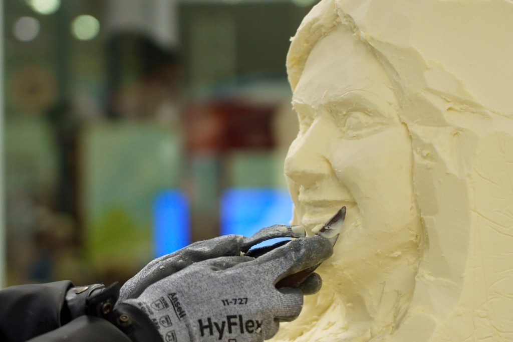 A sculptor carving a butter sculpture of Princess Kay of the Milky Way.