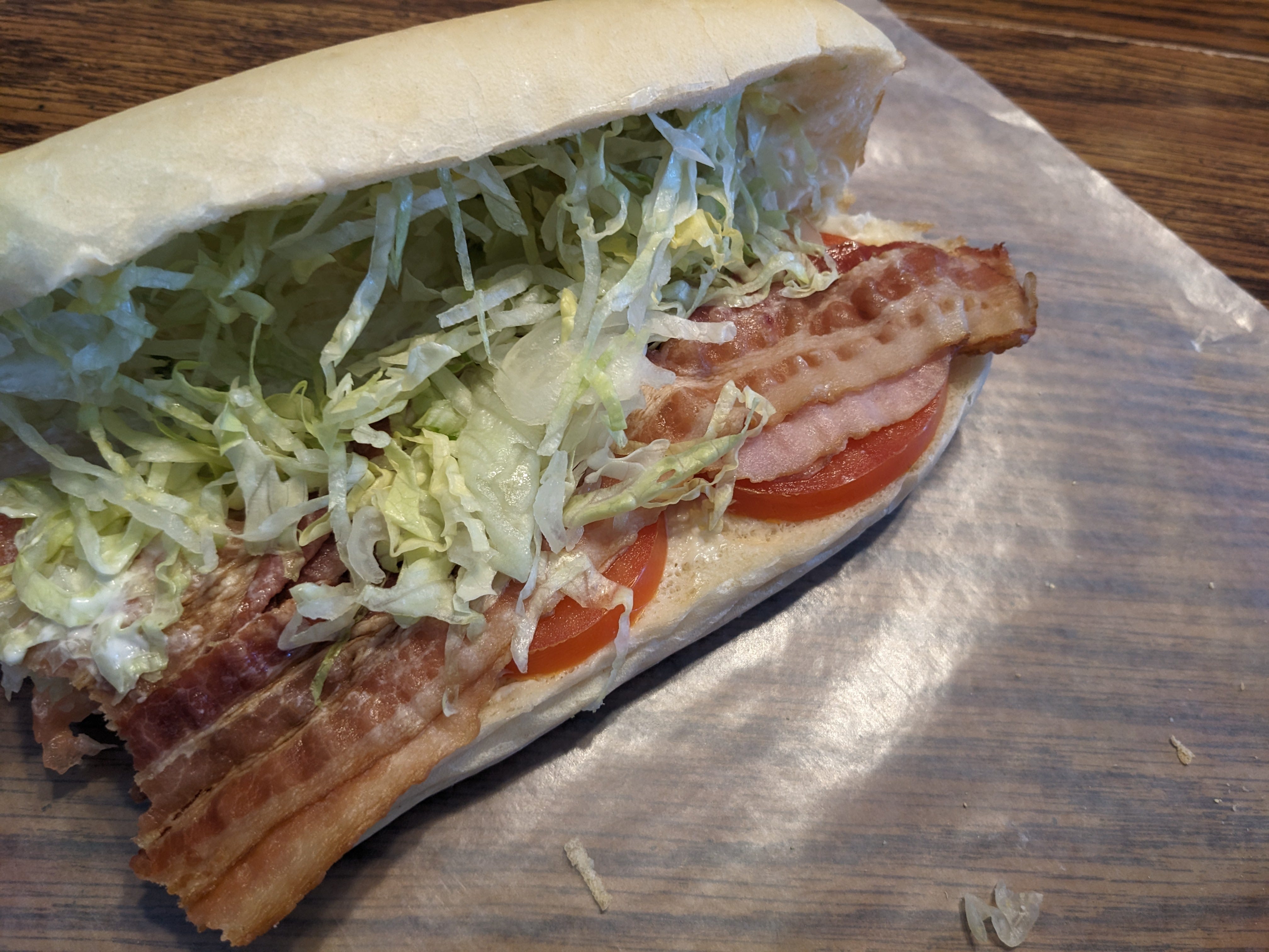 The author's opened BLT from Jimmy John's, highlighting the bread, lettuce, bacon, and tomatoes.