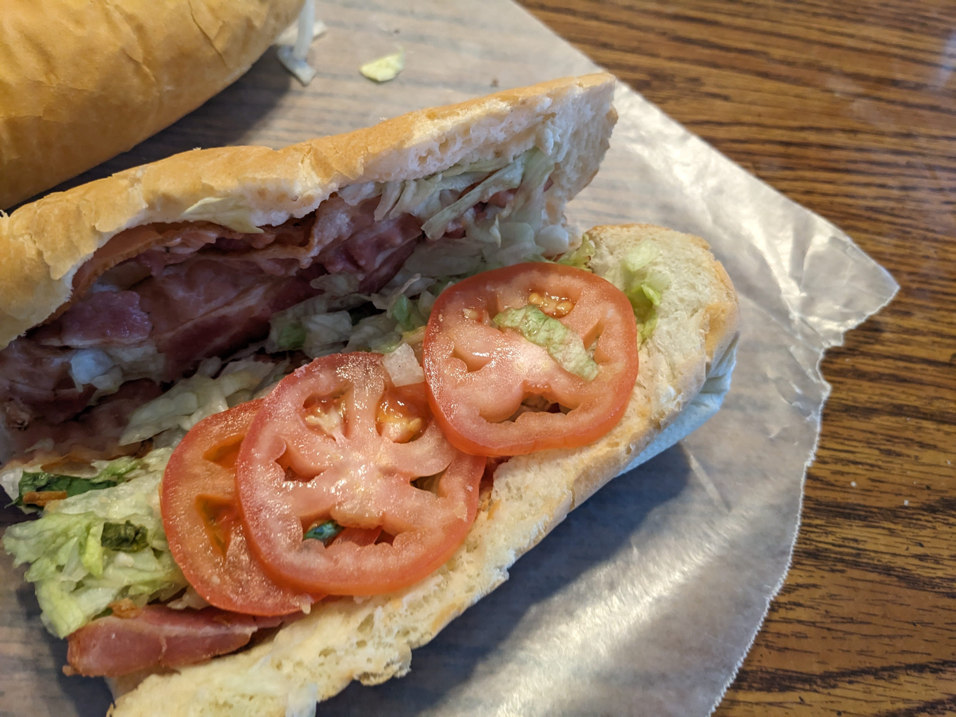 The author's opened BLT from Subway, highlighting the bread, lettuce, bacon, and tomatoes.