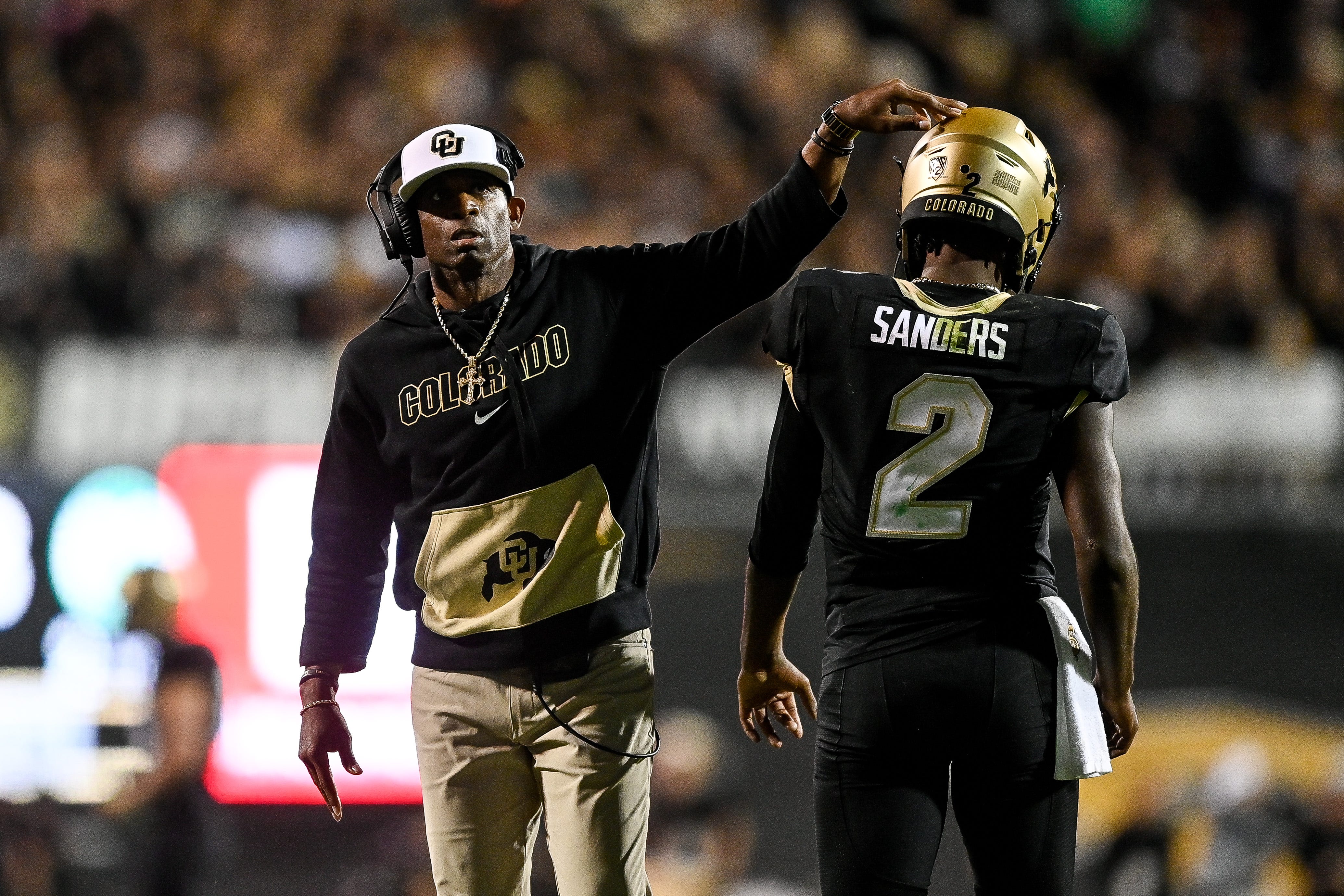 Head coach Deion Sanders of the Colorado Buffaloes celebrates with quarterback Shedeur Sanders #2 after a fourth quarter touchdown against the Colorado State Rams at Folsom Field on September 16, 2023 in Boulder, Colorado