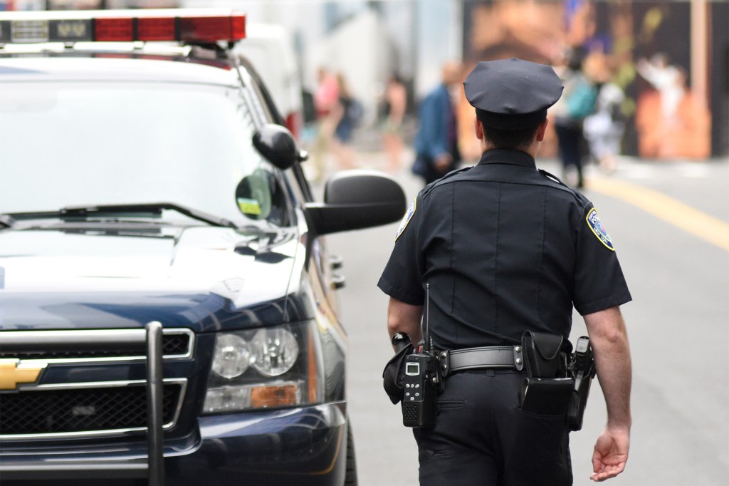 Four teens were shot during a street brawl in the Bronx on Friday. The image above is a stock photo of an NYPD officer.
