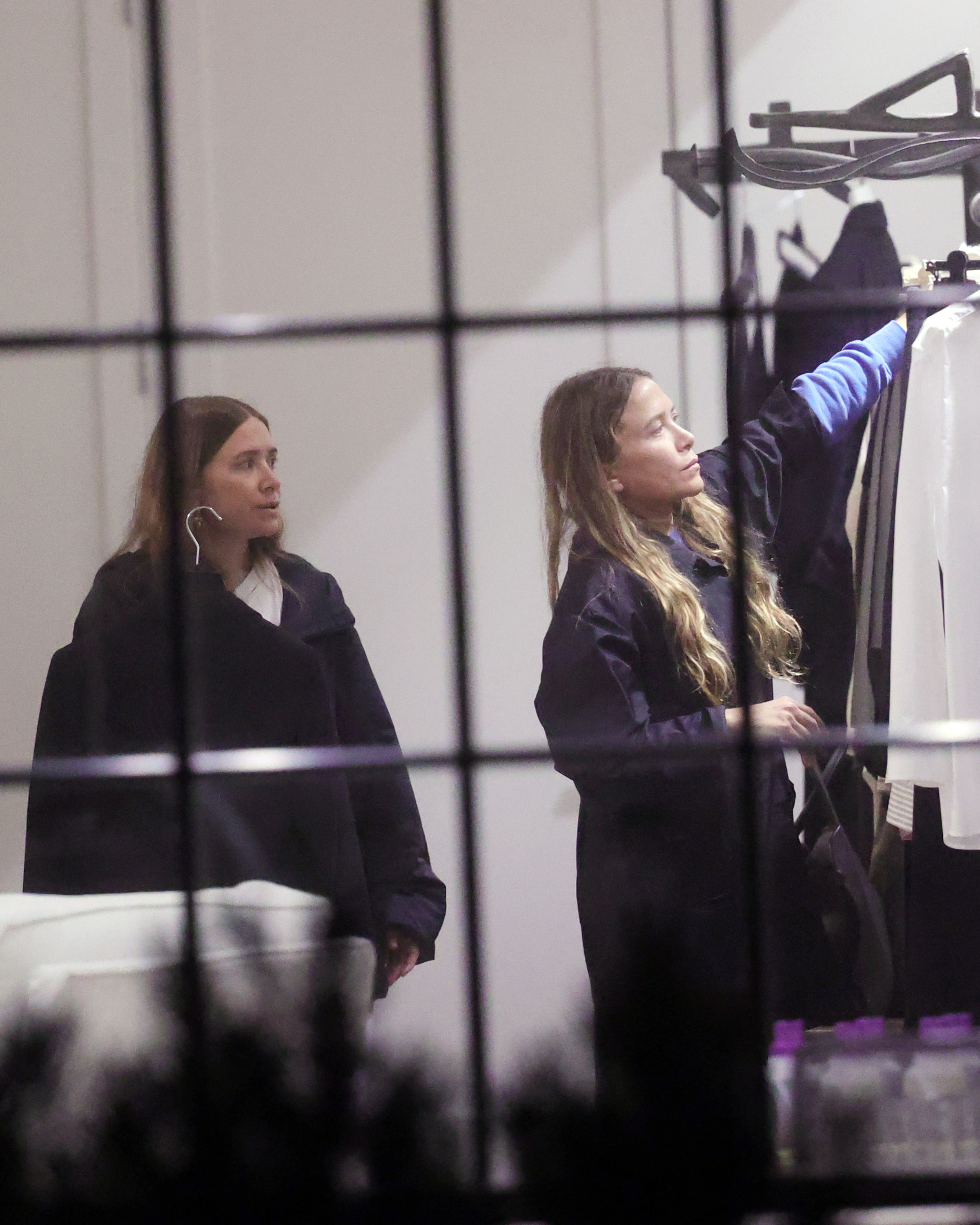 Mary-Kate and Ashley Olsen at a clothing rack at the their store. 