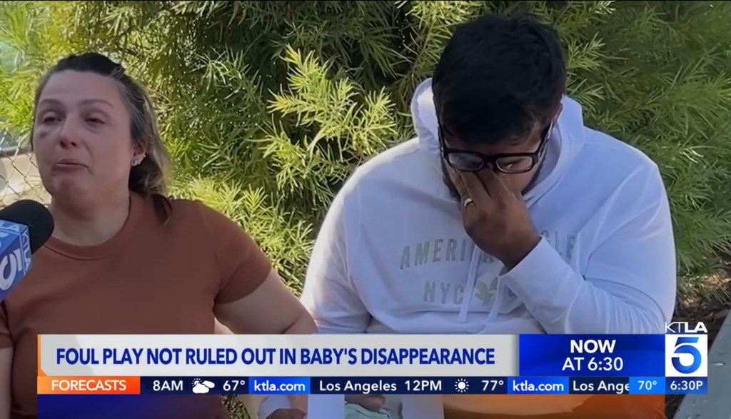 Jake Haro wipes tears from his eyes while being interviewed by a local news outlet during the search for his son. 