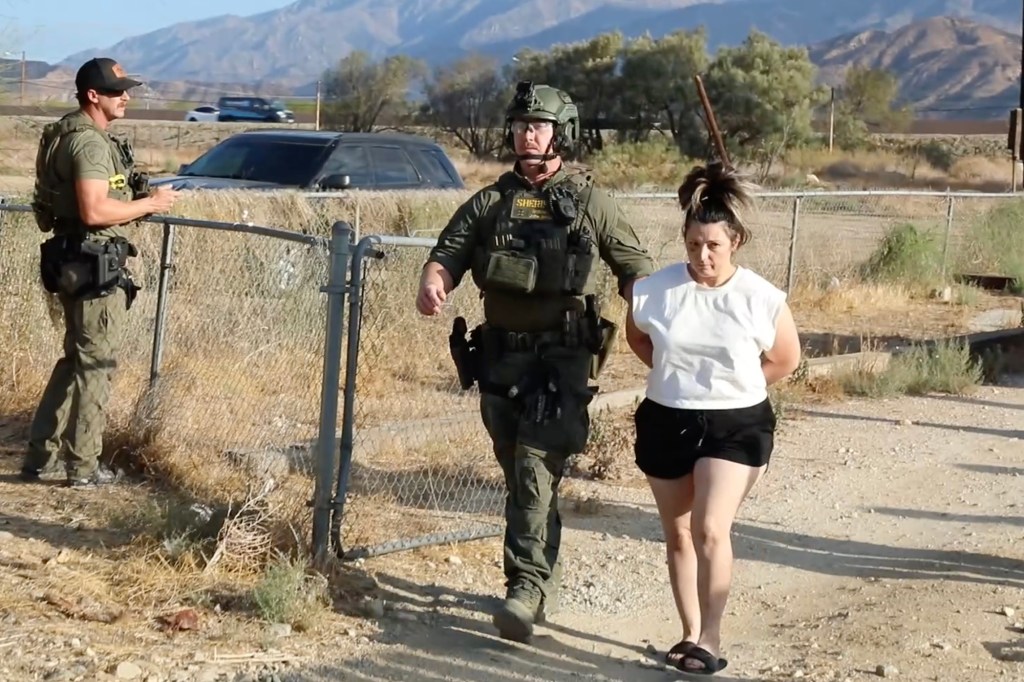 A handcuffed Rebecca Haro is escorted from her Cabazon home during her arrest in the suspected murder of 7-month-old Emmanuel Haro.