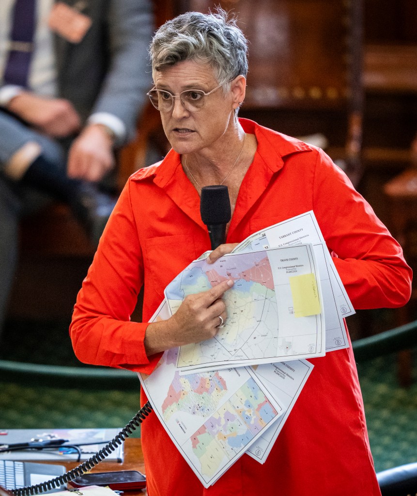 Texas Democratic state Sen. Sarah Eckhardt holds up proposed redistricting maps during debate.