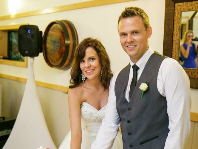 The author and her husband cutting the cake on their wedding day in 2015.